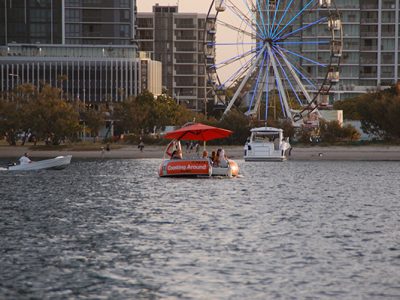 Orange Boat in front of a ferris wheel on the Broadwater Gold Coast