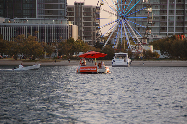 Orange Boat in front of a ferris wheel on the Broadwater Gold Coast