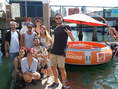 10 People about to jump on a orange round boat